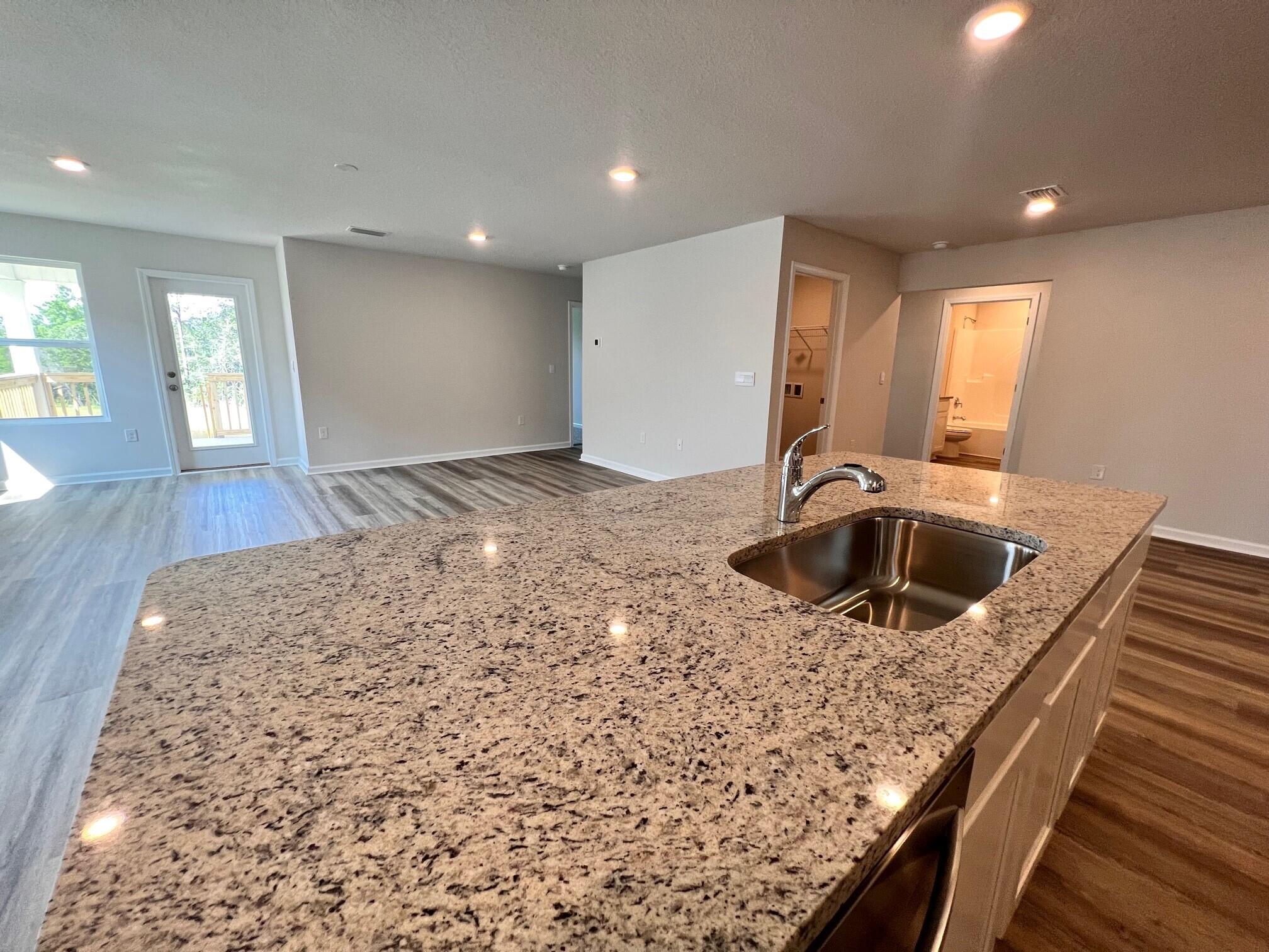 3021 Jane Lane Crestview, FL 32539 - Photo 2 of 16 a kitchen with a sink and a stove top oven