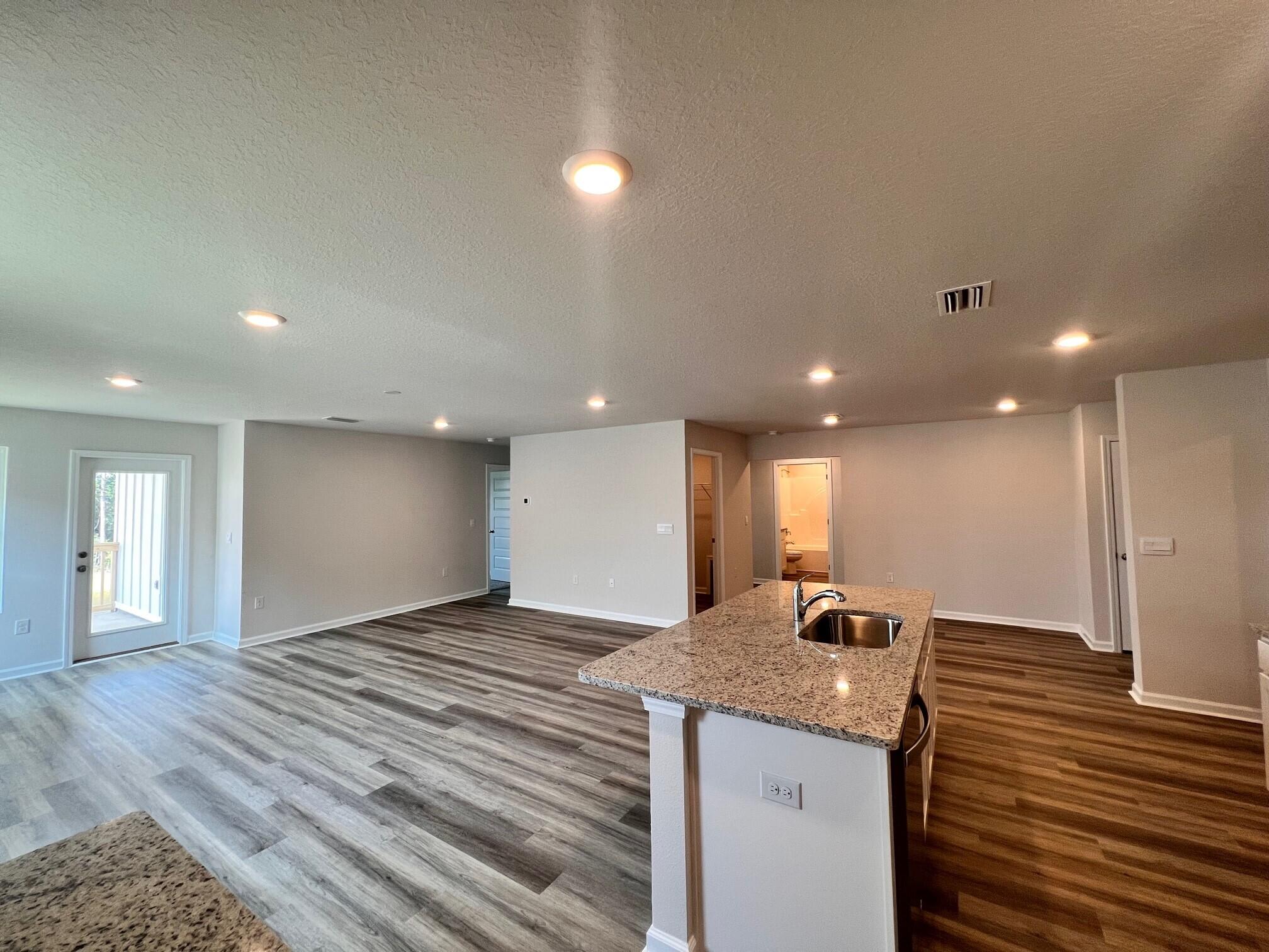 3021 Jane Lane Crestview, FL 32539 - Photo 6 of 16 a view of a kitchen with a sink and a refrigerator