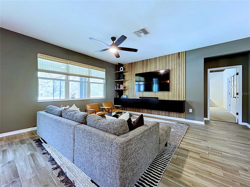 18078 Romanesque Court Spring Hill, FL 34610 - Photo 26 of 81 a living room with furniture and a flat screen tv