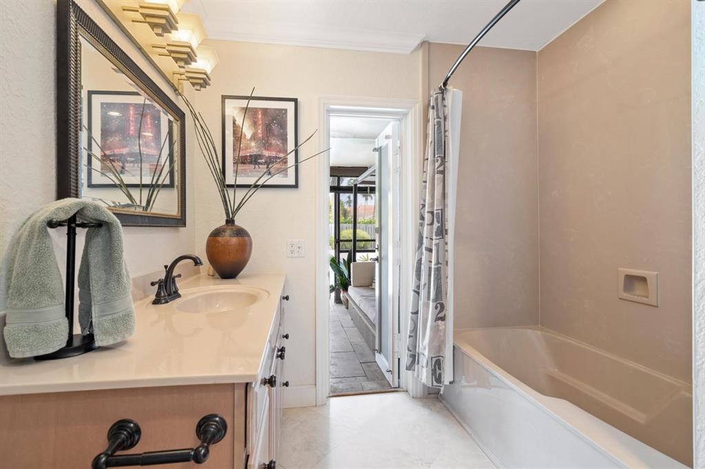 2750 Northeast 45th Street Lighthouse Point, FL 33064 - Photo 11 of 21 a bathroom with a tub and a sink