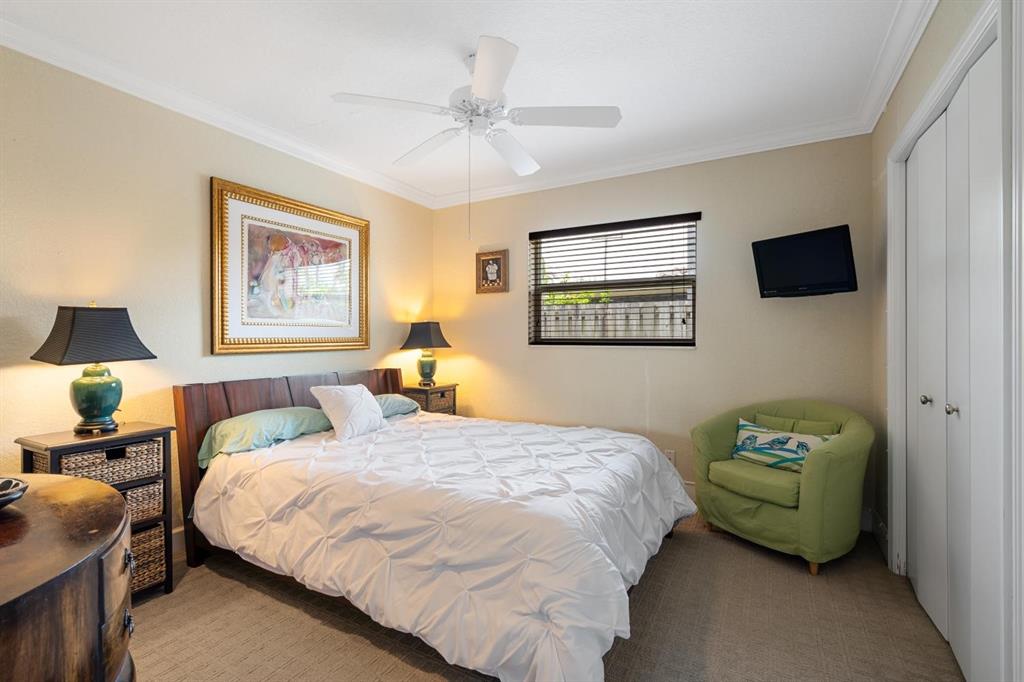 2750 Northeast 45th Street Lighthouse Point, FL 33064 - Photo 12 of 21 a bedroom with a bed and a chandelier