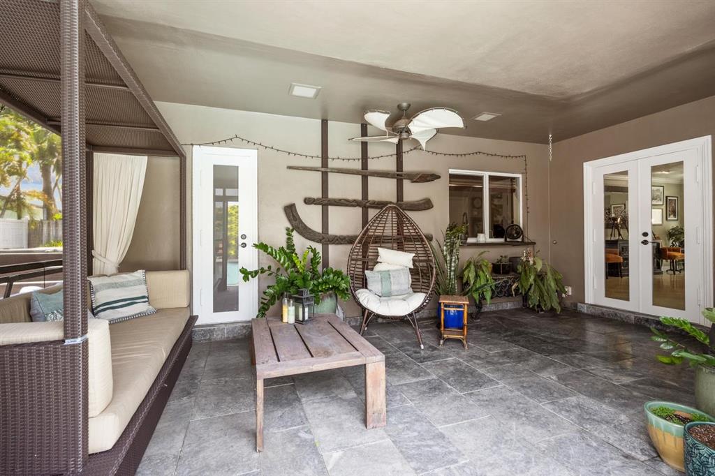 2750 Northeast 45th Street Lighthouse Point, FL 33064 - Photo 14 of 21 a view of a porch with chairs and potted plants