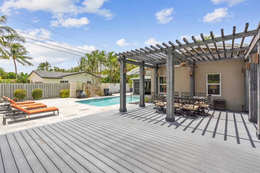 2750 Northeast 45th Street Lighthouse Point, FL 33064 - Photo 19 of 21 a view of a patio with dining table and chairs with wooden floor