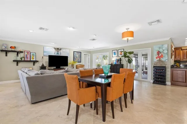 a view of a dining room with furniture and a flat screen tv
