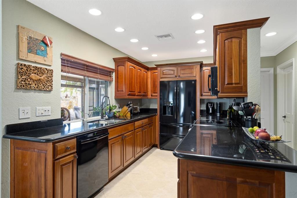 2750 Northeast 45th Street Lighthouse Point, FL 33064 - Photo 5 of 21 a kitchen with stainless steel appliances a sink stove and cabinets