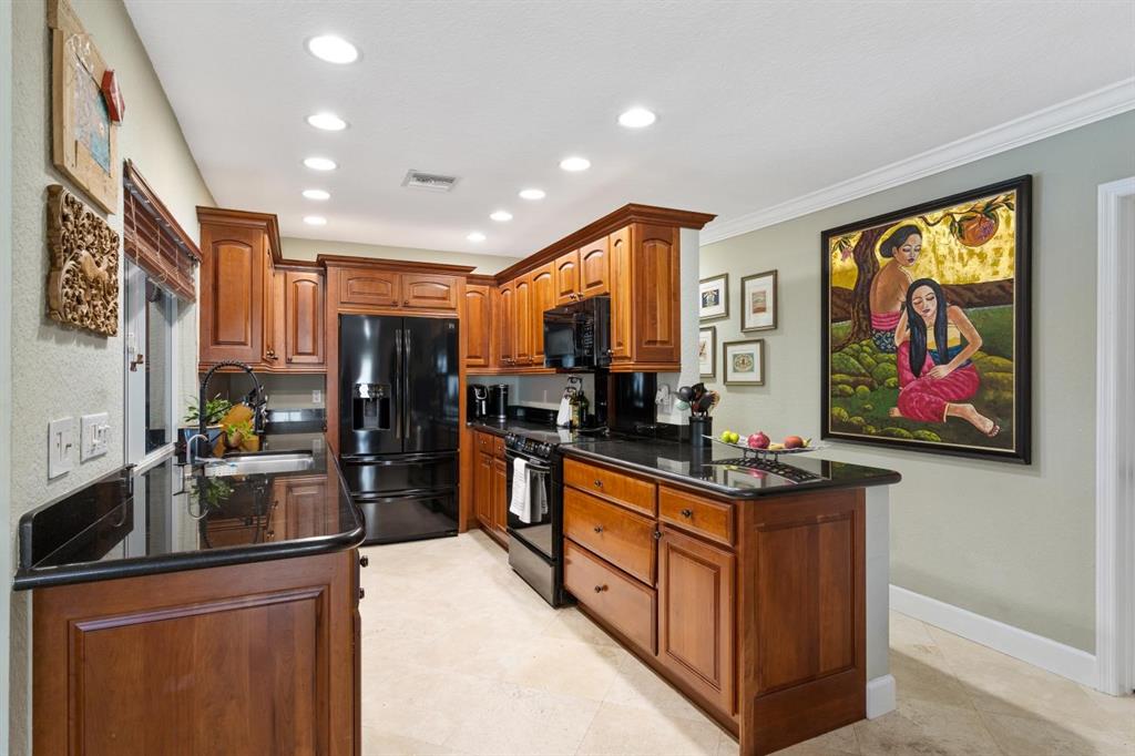 2750 Northeast 45th Street Lighthouse Point, FL 33064 - Photo 6 of 21 a kitchen with stainless steel appliances kitchen island granite countertop a refrigerator and a stove