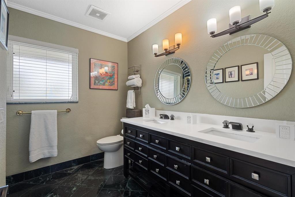 2750 Northeast 45th Street Lighthouse Point, FL 33064 - Photo 8 of 21 a bathroom with a toilet sink and mirror