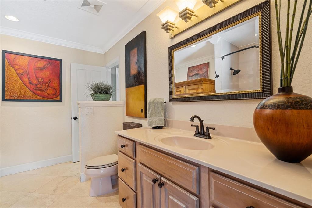 2750 Northeast 45th Street Lighthouse Point, FL 33064 - Photo 10 of 21 a bathroom with a sink a mirror and a toilet