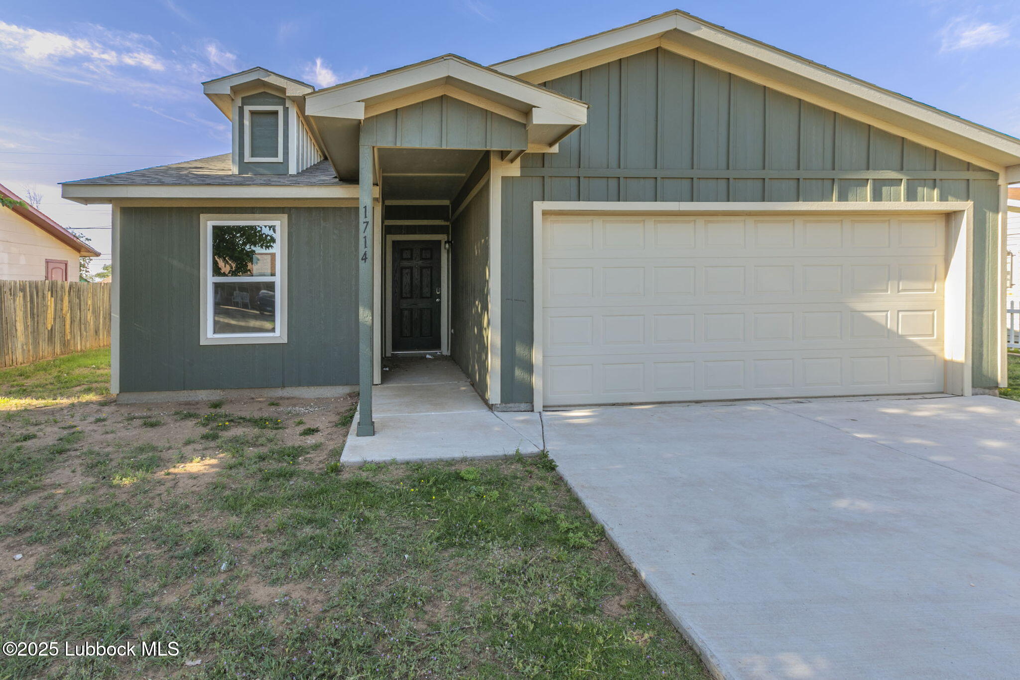 1714 East Cornell Street Lubbock, TX 79403 - Photo 1 of 18 a front view of a house with a yard and garage