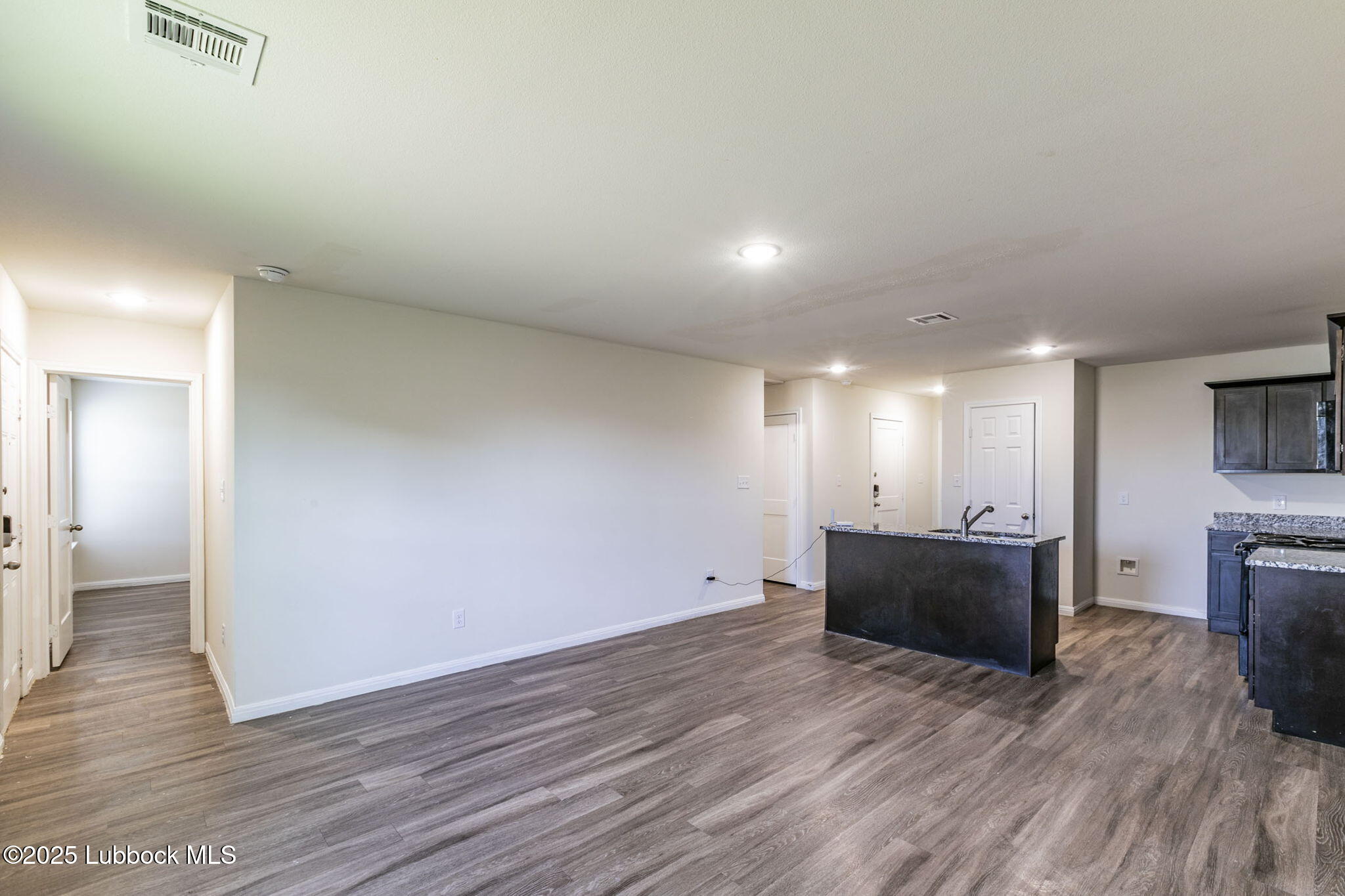 1714 East Cornell Street Lubbock, TX 79403 - Photo 4 of 18 a view of empty room with wooden floor