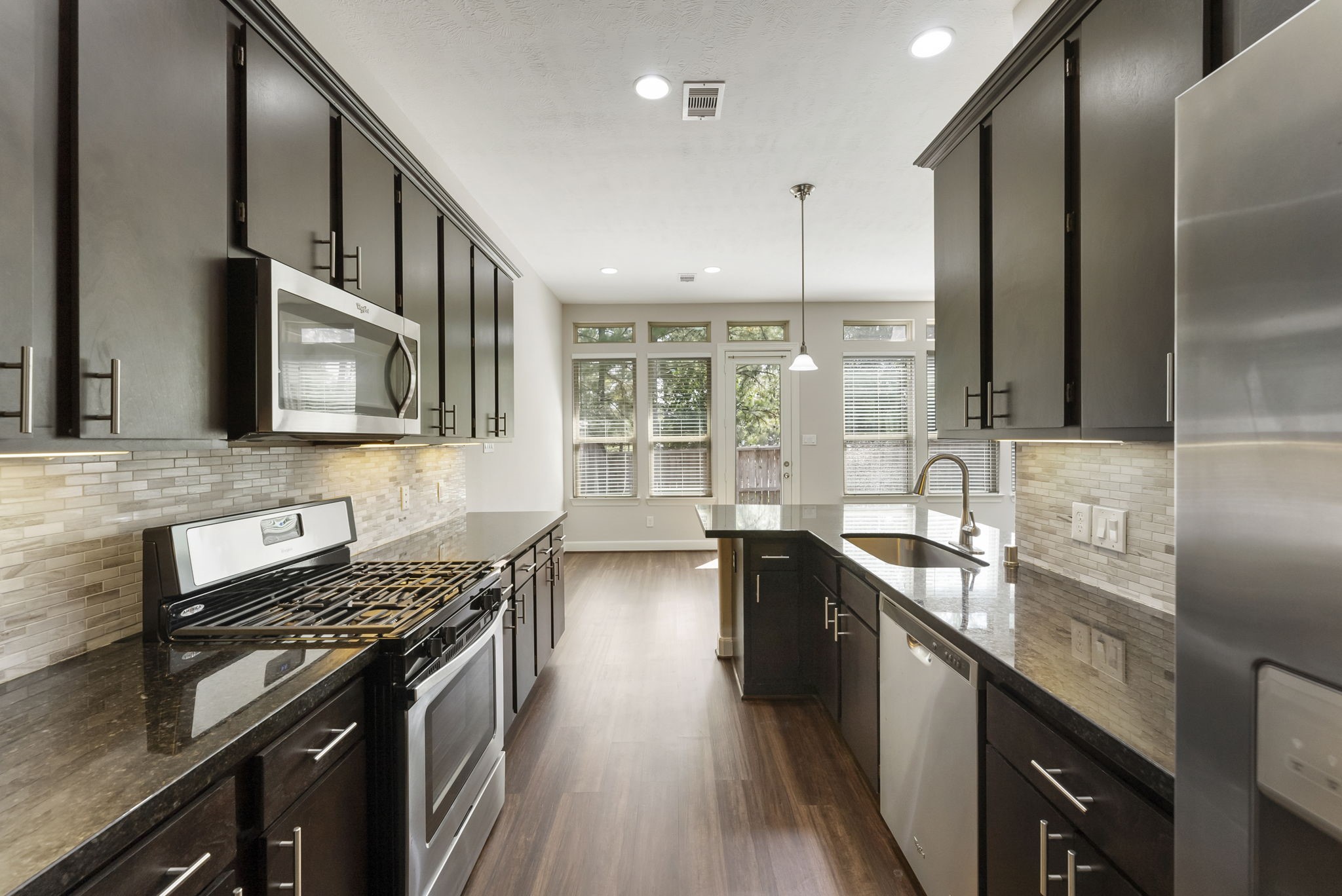 a kitchen with stainless steel appliances granite countertop a stove and a sink