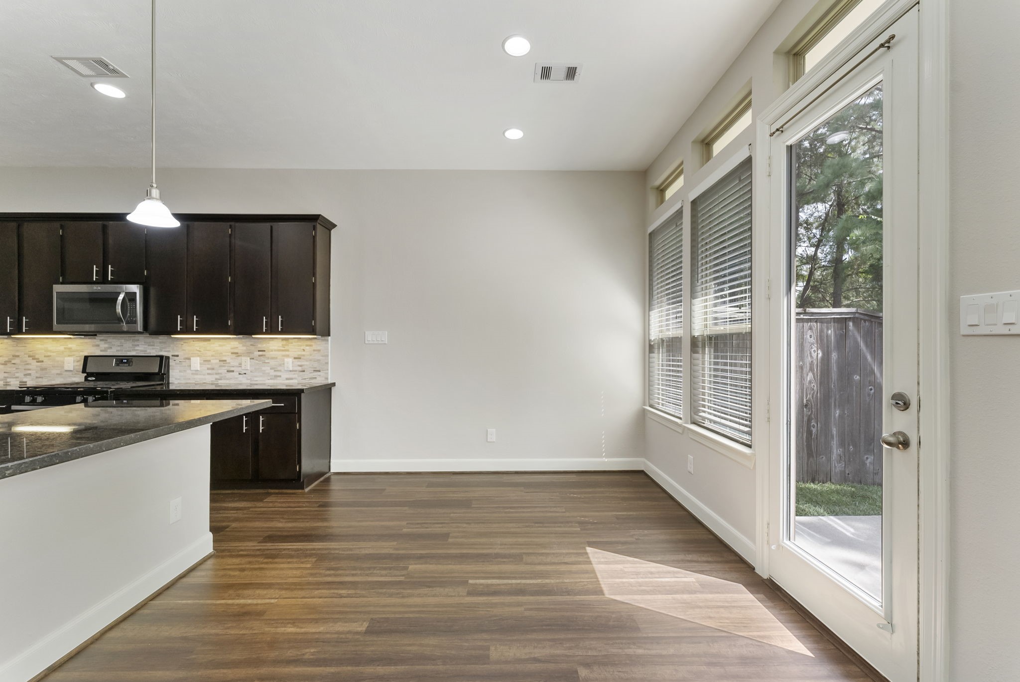 31 Aventura Place Spring, TX 77389 - Photo 11 of 49 a kitchen with granite countertop a stove a sink and a refrigerator