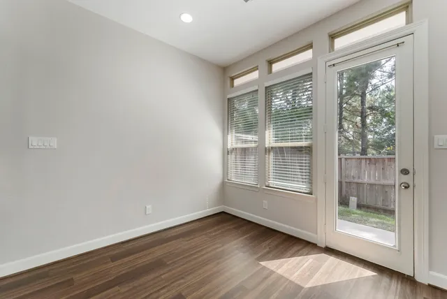 a kitchen with granite countertop a stove a sink and a microwave