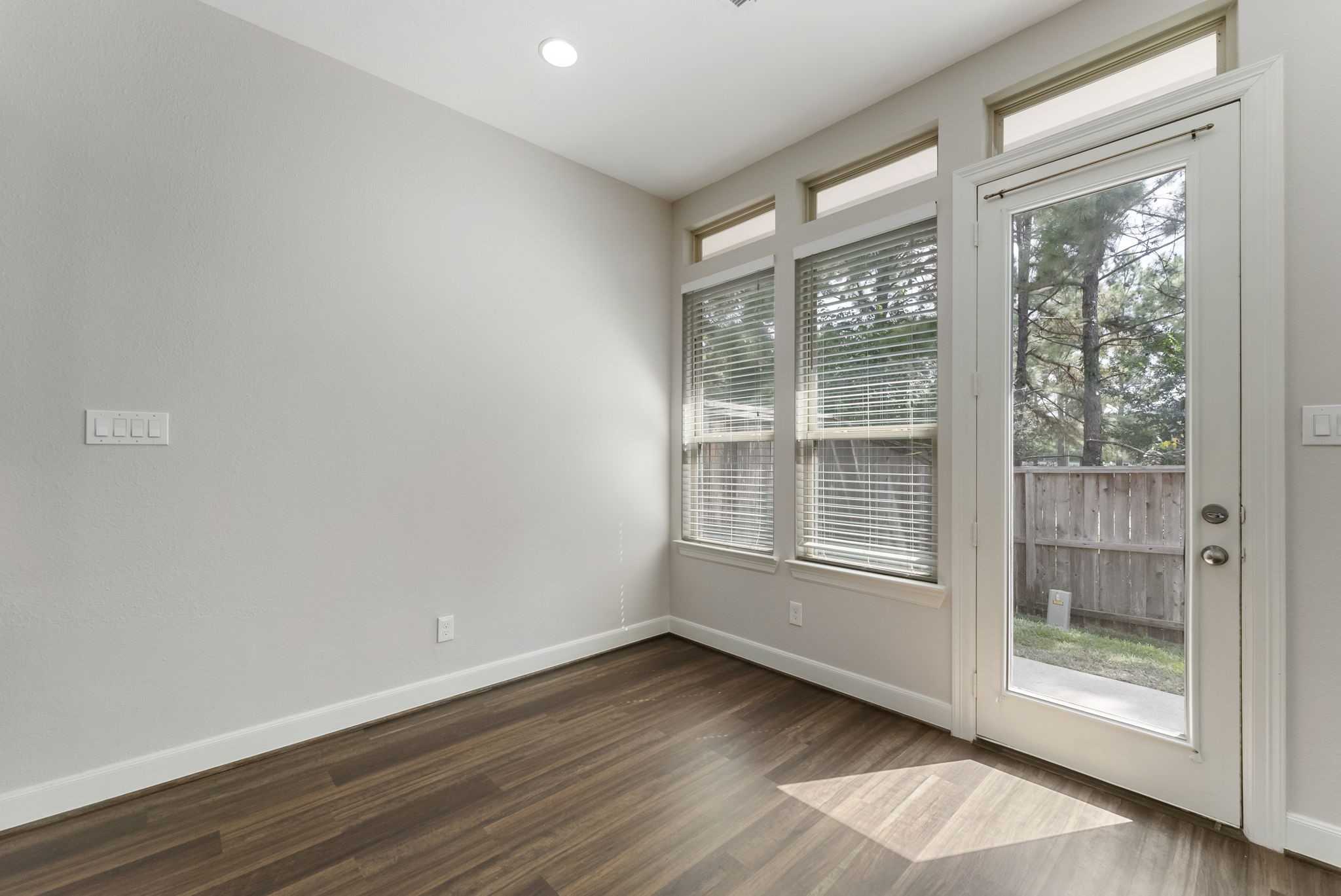 31 Aventura Place Spring, TX 77389 - Photo 12 of 49 a view of an empty room with wooden floor and a window