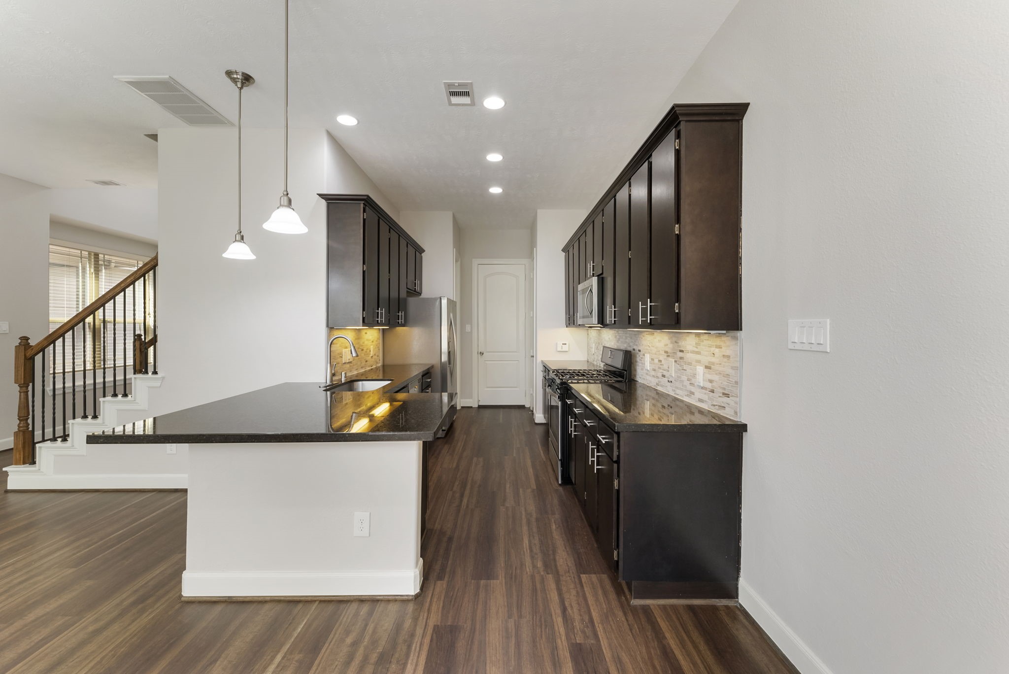 31 Aventura Place Spring, TX 77389 - Photo 14 of 49 a kitchen with stainless steel appliances granite countertop a stove a sink and a refrigerator