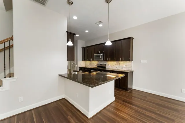an empty room with windows and ceiling fan