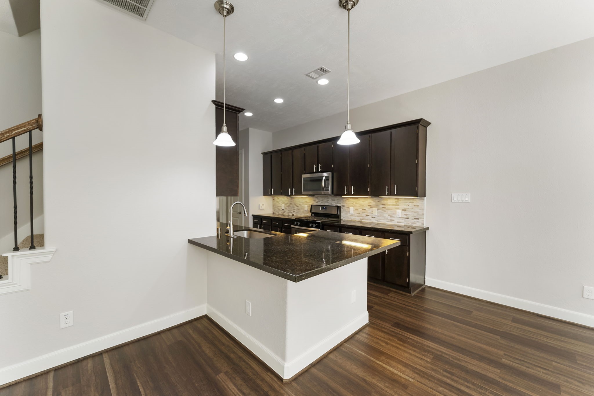 31 Aventura Place Spring, TX 77389 - Photo 15 of 49 a kitchen with stainless steel appliances granite countertop a sink and a stove