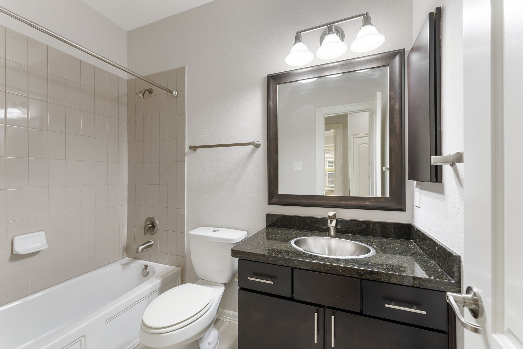 31 Aventura Place Spring, TX 77389 - Photo 24 of 49 a bathroom with a sink toilet a mirror and shower