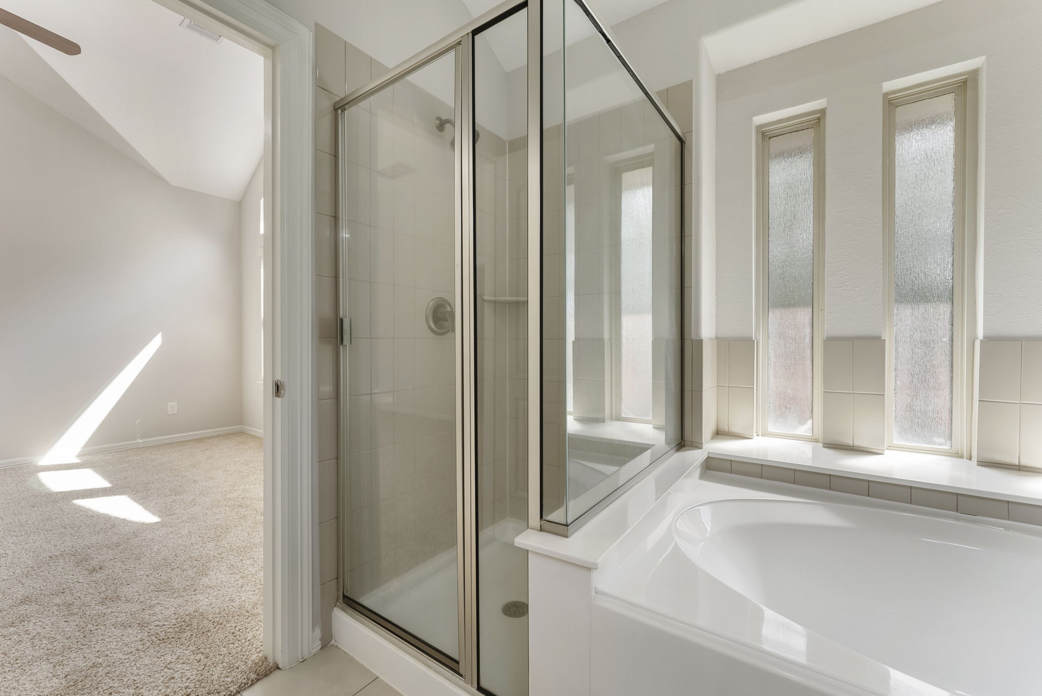 31 Aventura Place Spring, TX 77389 - Photo 37 of 49 a bathroom with a glass shower door and a glass door shower