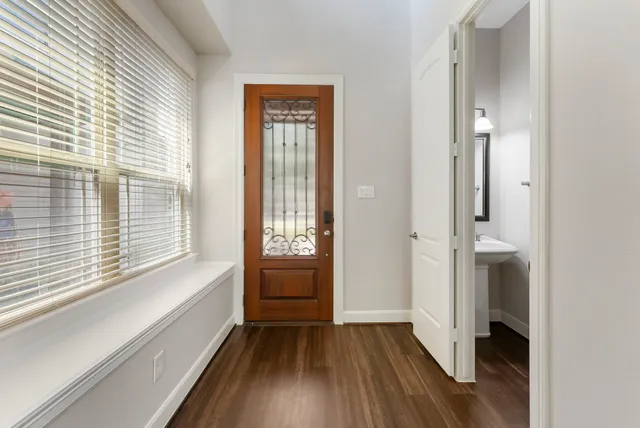a view of a kitchen with a sink and wooden floor