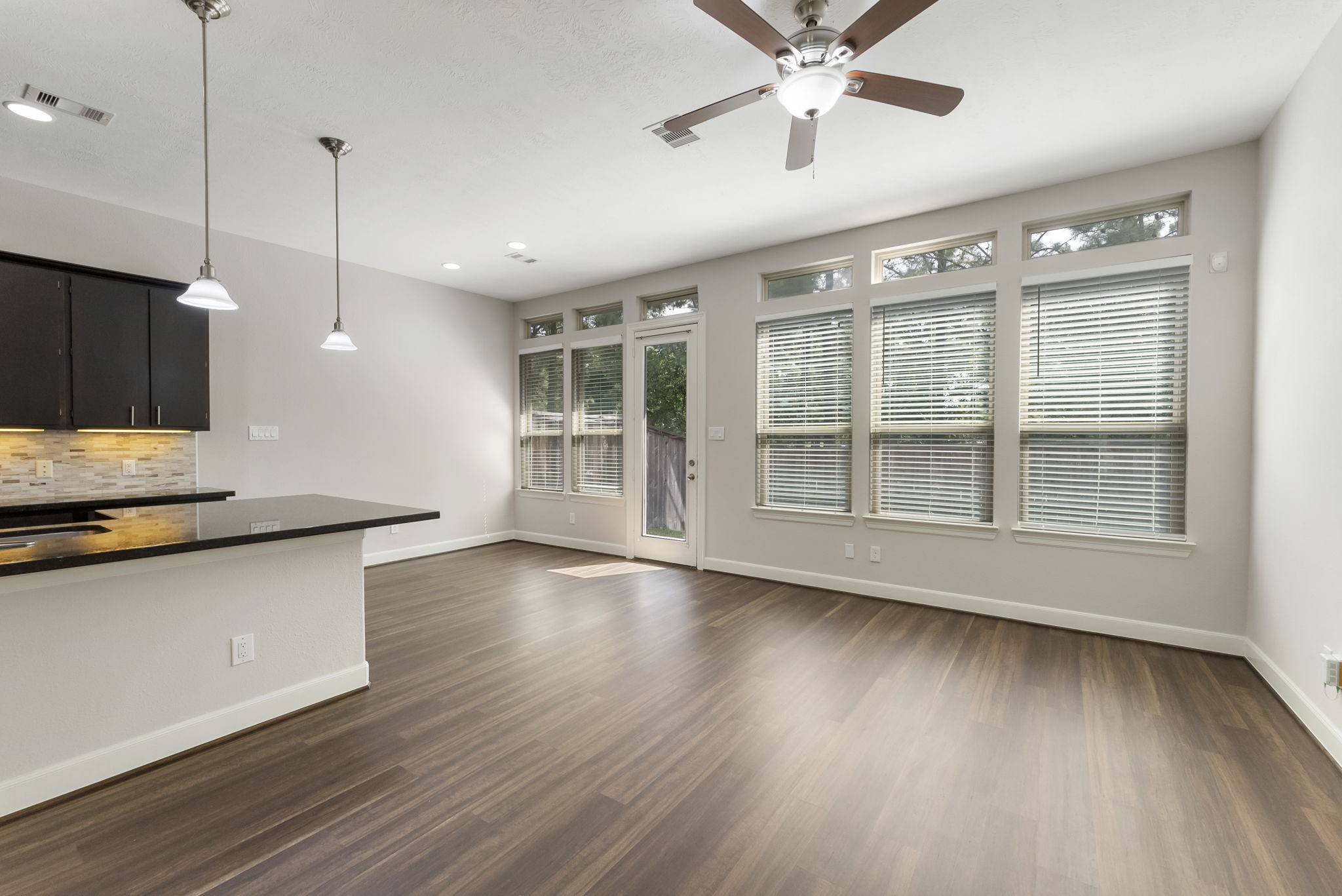 31 Aventura Place Spring, TX 77389 - Photo 7 of 49 a view of a kitchen with a sink and wooden floor