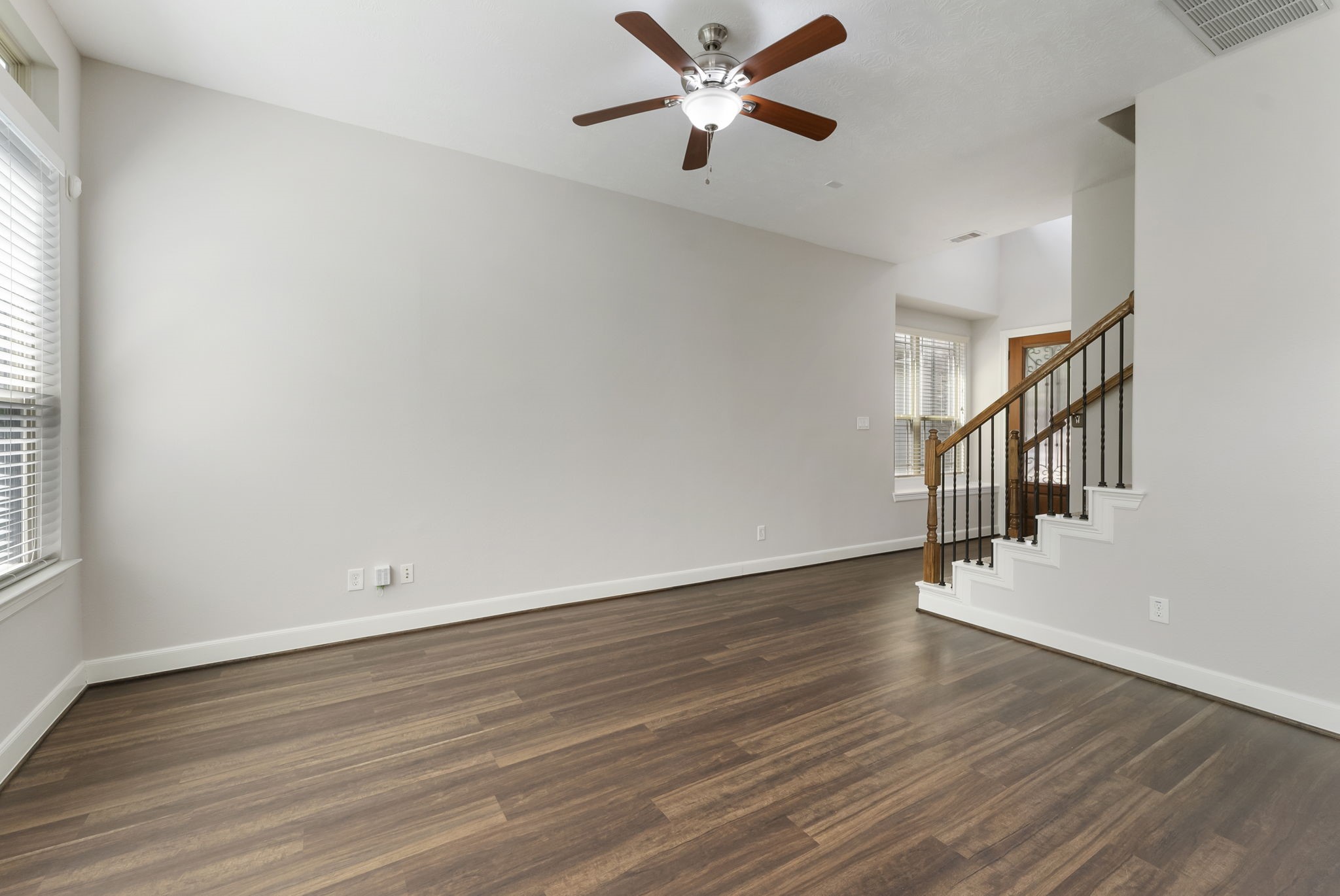 31 Aventura Place Spring, TX 77389 - Photo 9 of 49 wooden floor in an empty room with a window