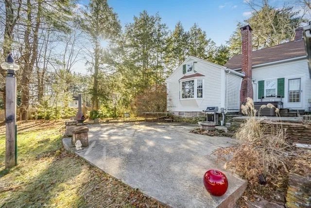 a view of a house with backyard and sitting area