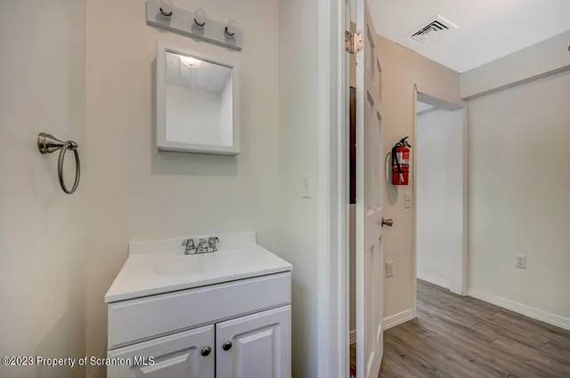 a bathroom with a shower sink and mirror