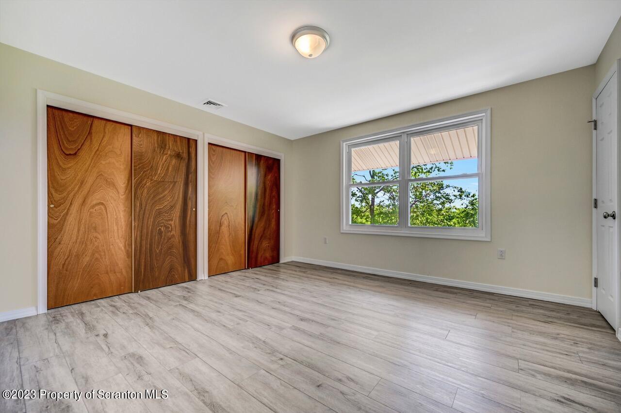 51 Butler Hill Road Lake Ariel, PA 18436 - Photo 19 of 33 a view of an empty room with wooden floor and a window