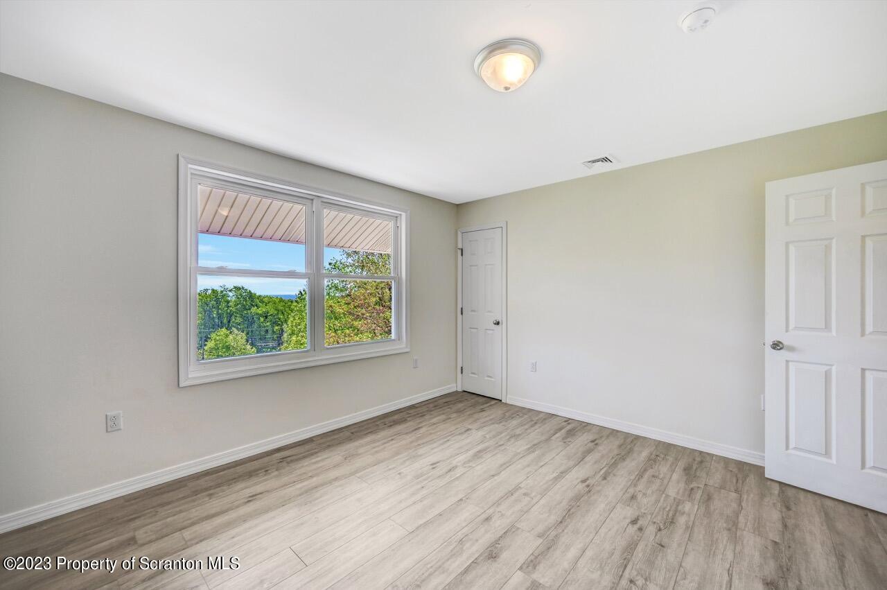51 Butler Hill Road Lake Ariel, PA 18436 - Photo 21 of 33 an empty room with wooden floor and windows