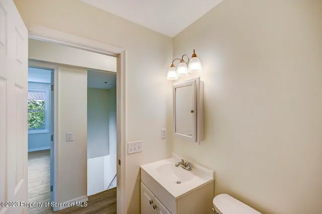 a bathroom with a toilet sink and mirror
