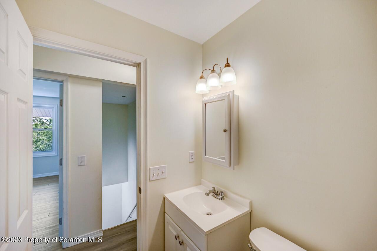 51 Butler Hill Road Lake Ariel, PA 18436 - Photo 23 of 33 a bathroom with a toilet sink and mirror