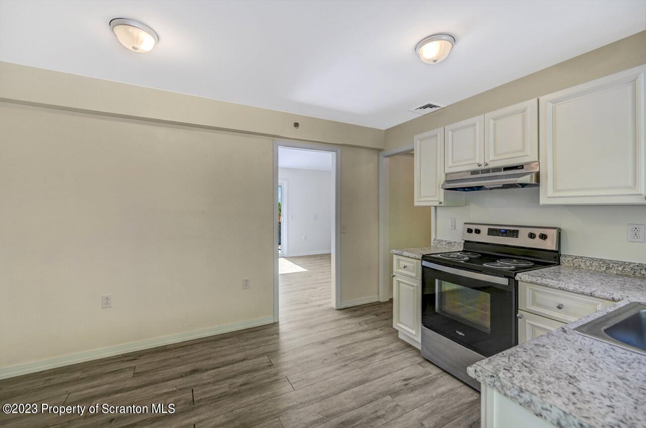 51 Butler Hill Road Lake Ariel, PA 18436 - Photo 6 of 33 a kitchen with granite countertop a stove and a refrigerator