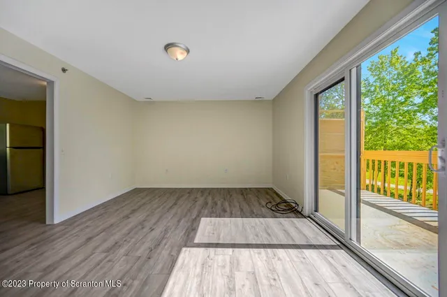 wooden floor in an empty room with a large window