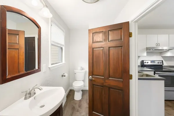 a view of a kitchen with wooden floor and sink