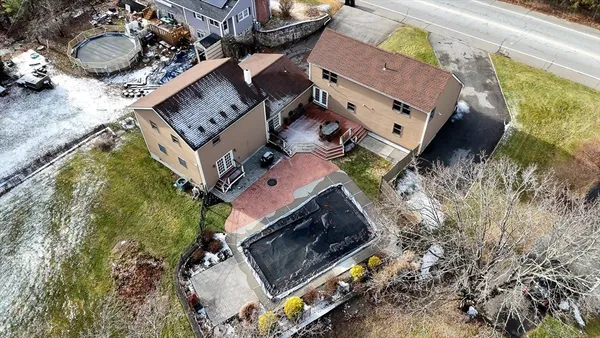an aerial view of a house with a yard and a garage
