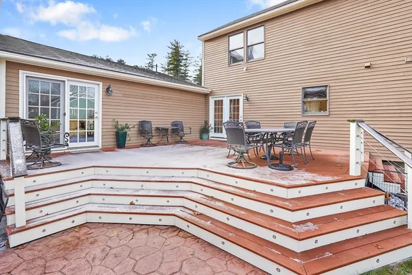 a view of a patio with a dining table and chairs