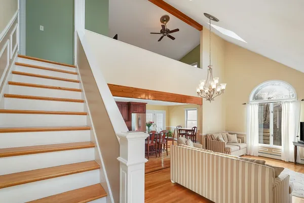 a view of a hallway view with wooden floor and staircase
