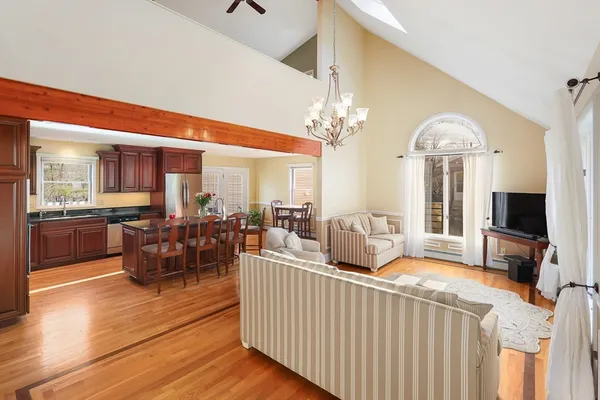 a living room with furniture and a chandelier