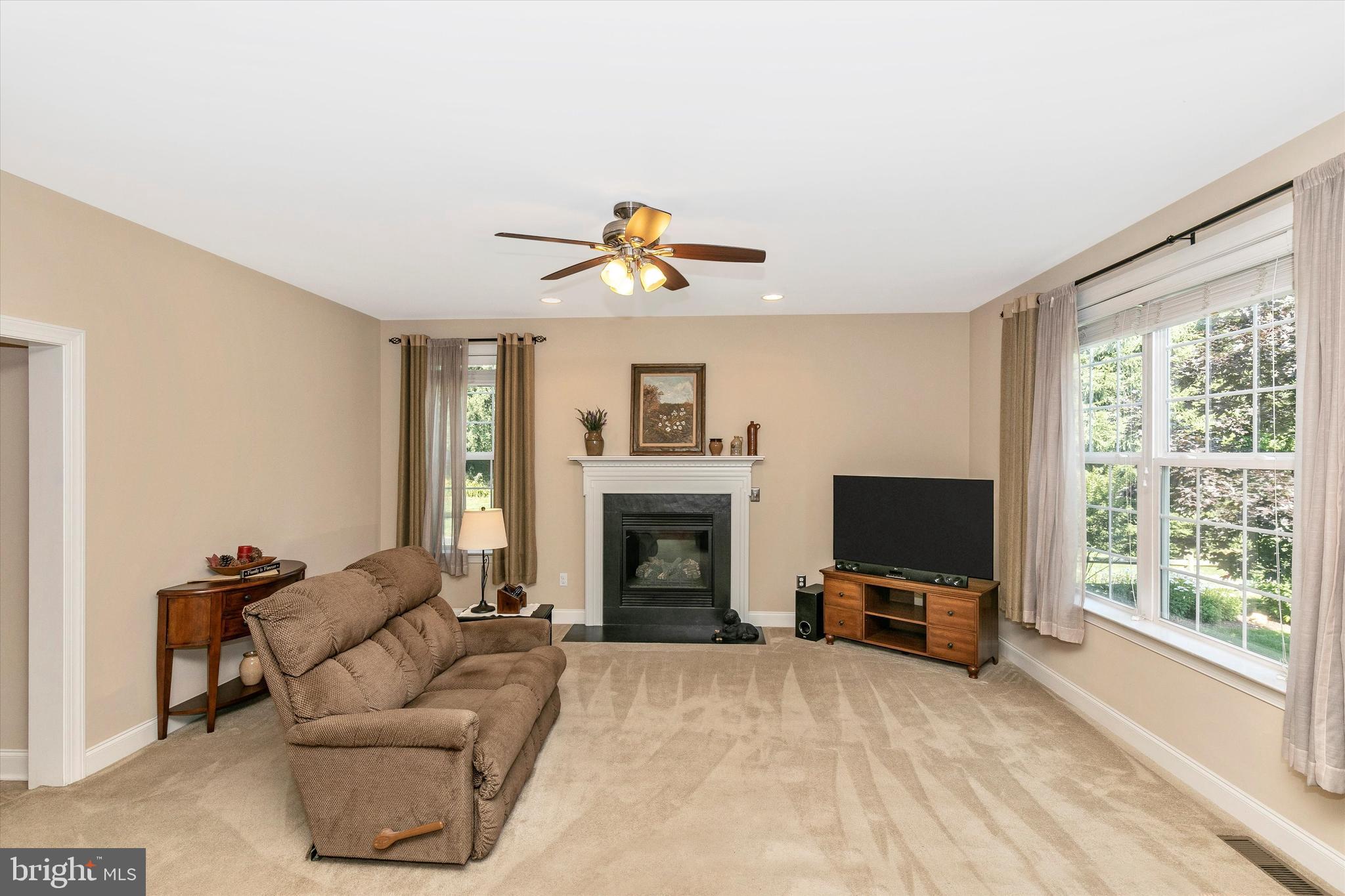 484 Hopewell Road Downingtown, PA 19335 - Photo 17 of 112 Family room with ceiling fan and fireplace