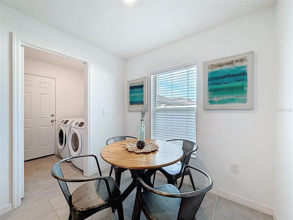 12943 Impatiens Street Spring Hill, FL 34609 - Photo 14 of 53 a view of a room that has a table and chairs
