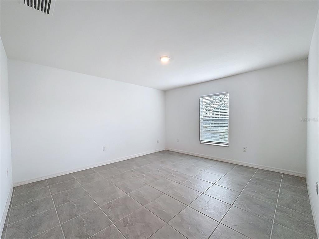 12943 Impatiens Street Spring Hill, FL 34609 - Photo 16 of 53 a view of an empty room with a window
