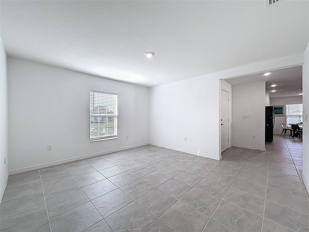 12943 Impatiens Street Spring Hill, FL 34609 - Photo 18 of 53 a view of an empty room with a window