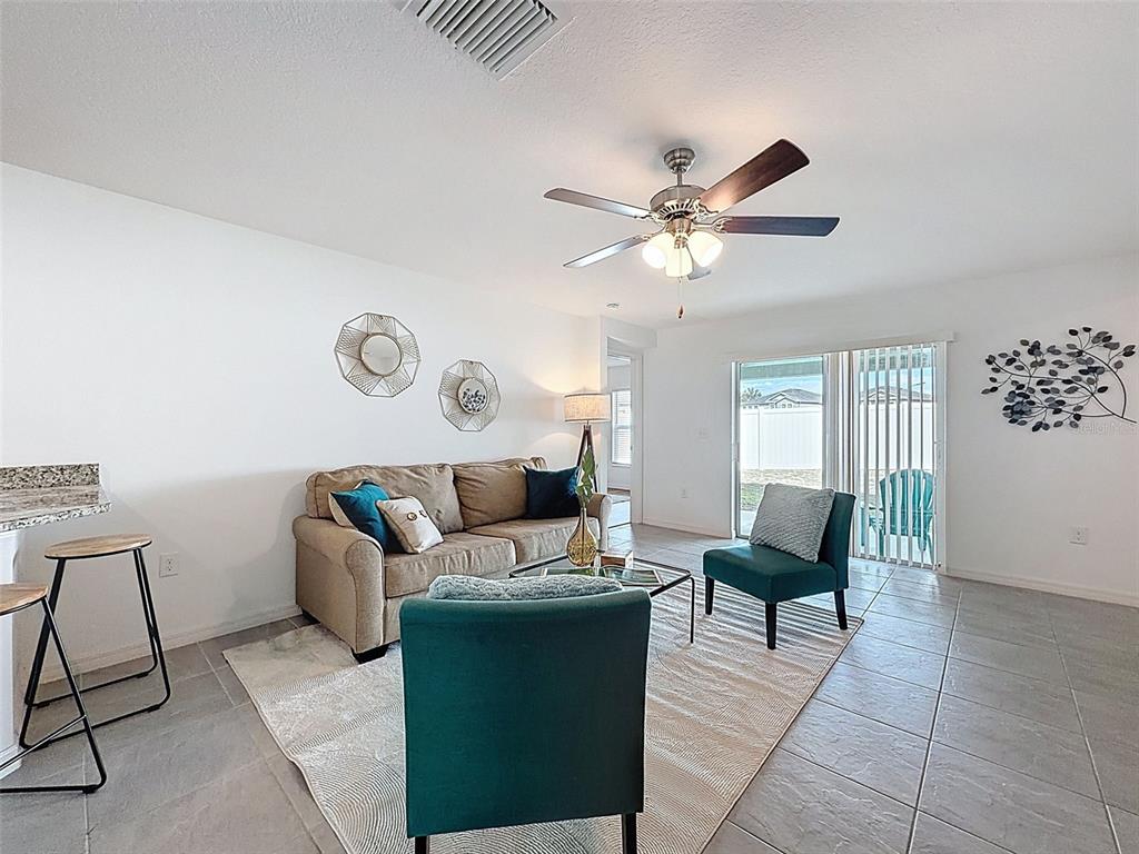 12943 Impatiens Street Spring Hill, FL 34609 - Photo 19 of 53 a living room with furniture and a window