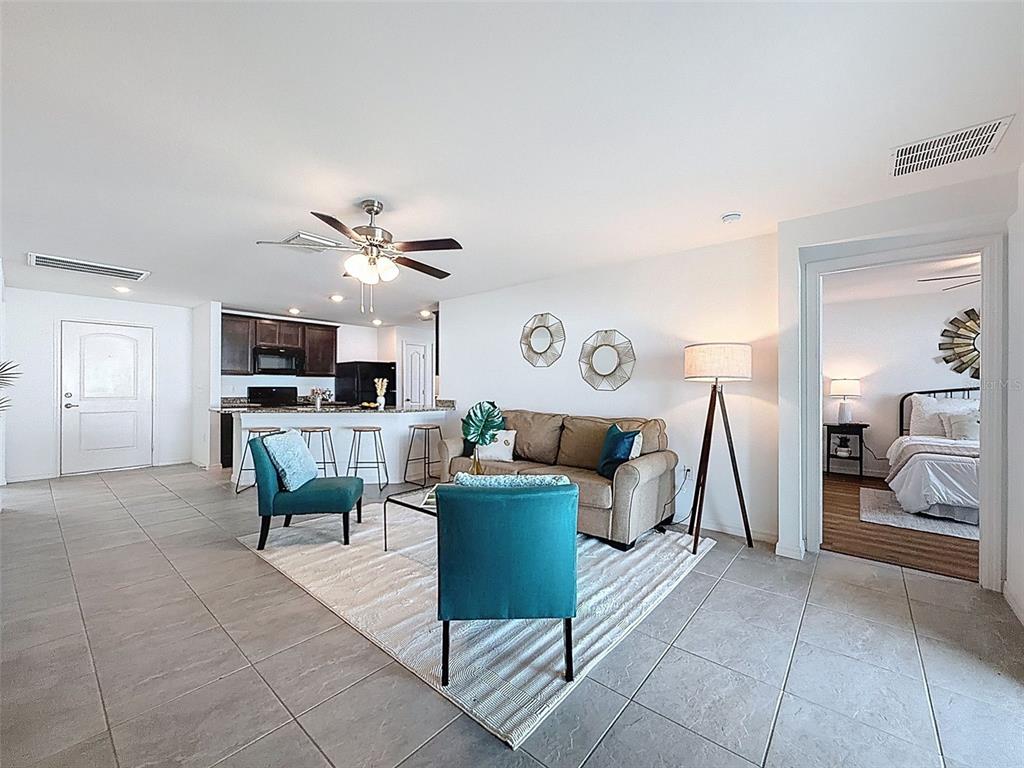 12943 Impatiens Street Spring Hill, FL 34609 - Photo 22 of 53 a living room with furniture and kitchen view