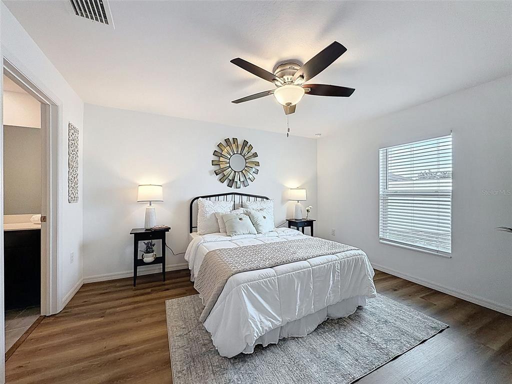 12943 Impatiens Street Spring Hill, FL 34609 - Photo 23 of 53 a bedroom with a large bed and a window