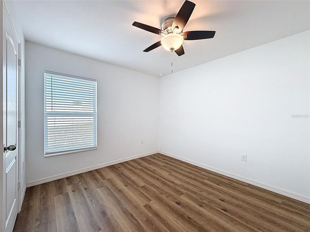 12943 Impatiens Street Spring Hill, FL 34609 - Photo 30 of 53 an empty room with a window and a fan