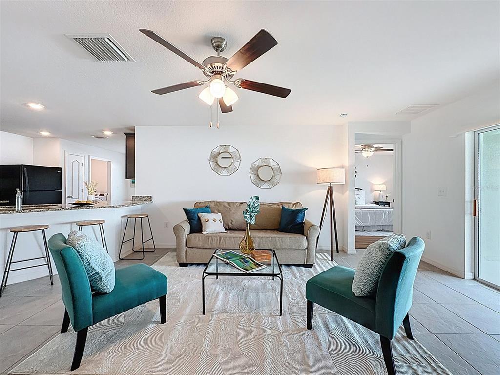 12943 Impatiens Street Spring Hill, FL 34609 - Photo 3 of 53 a living room with furniture and a wooden floor