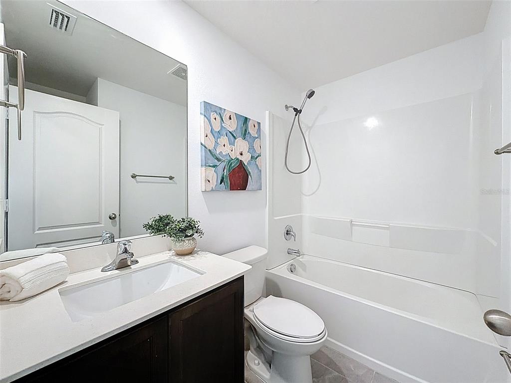 12943 Impatiens Street Spring Hill, FL 34609 - Photo 33 of 53 a bathroom with a sink a toilet and a bathtub