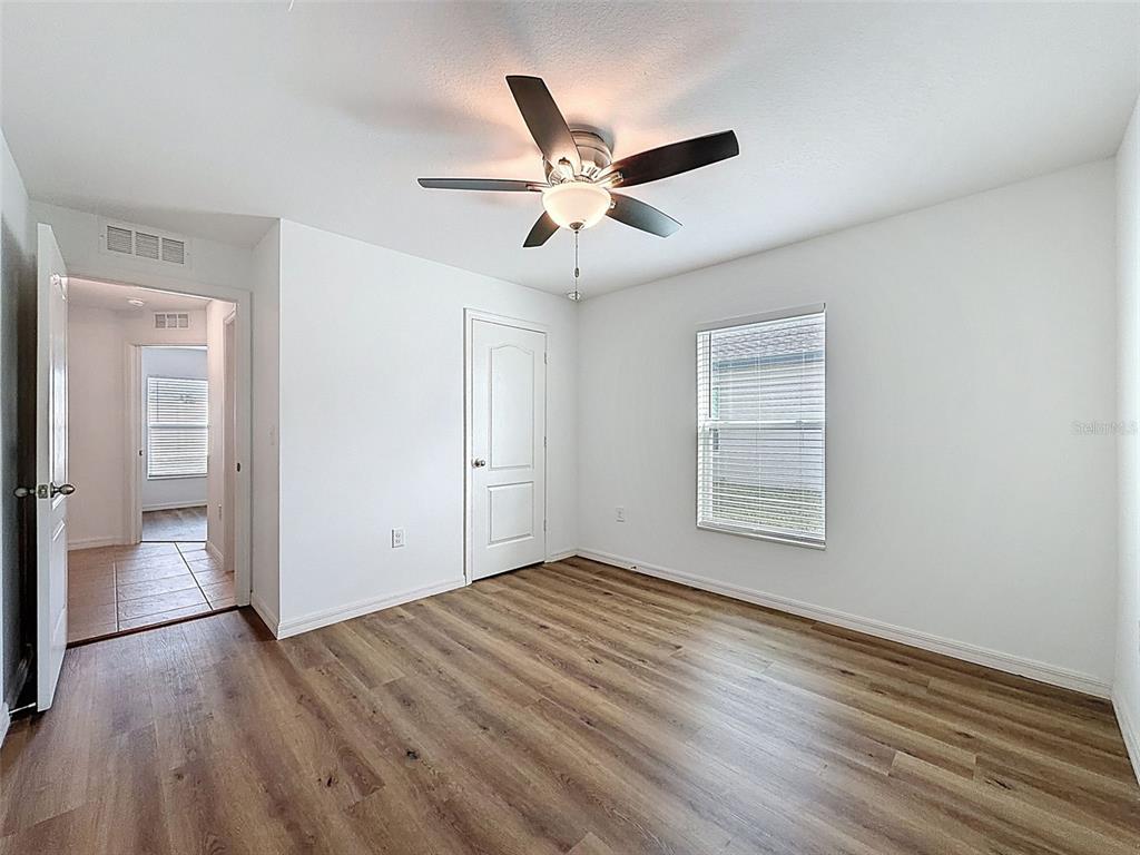 12943 Impatiens Street Spring Hill, FL 34609 - Photo 36 of 53 wooden floor in an empty room with a window